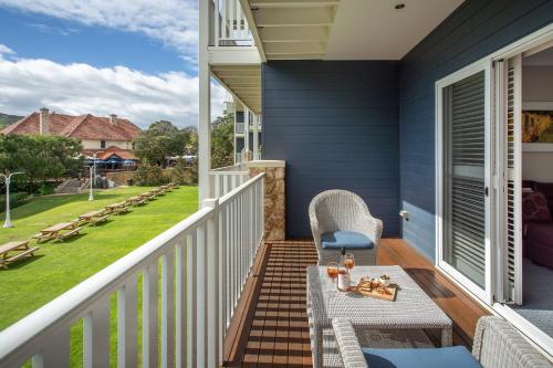 a patio with a table and chairs on a balcony at Seashells Yallingup in Yallingup