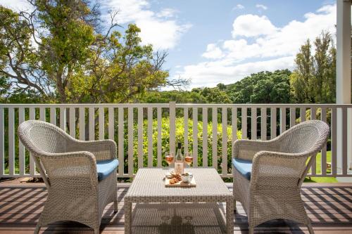 two chairs and a table on a deck at Seashells Yallingup in Yallingup