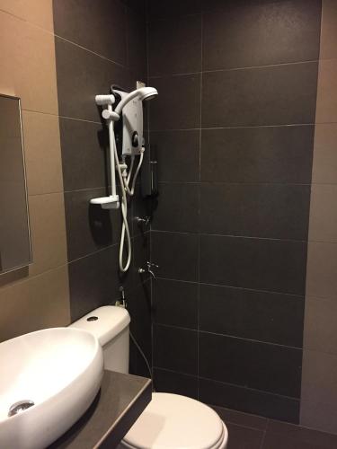 a bathroom with a toilet and a shower at Homestay Muar in Muar