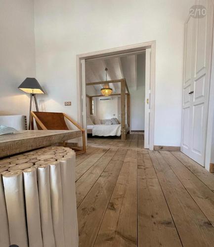 a large room with a bed and a mirror at Finca Hotel Rural Es Turó in Ses Salines