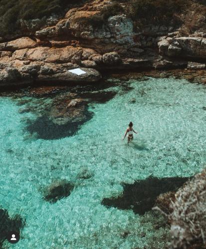 a woman standing in a body of water at Villa Station by Cassai in Ses Salines