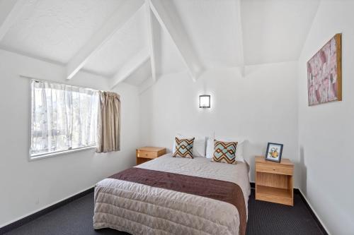 a bedroom with a bed and a window at Ascot Vale Motor Lodge in Christchurch