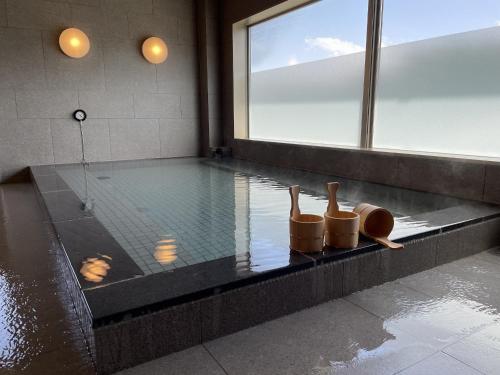 a swimming pool with a pair of shoes on the edge at Yukari no Mori in Fujikawaguchiko
