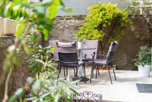 a table and chairs sitting on a patio at Studio Apartment Vittoria in Lovran
