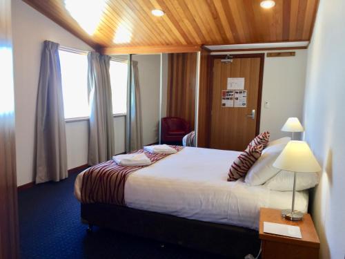 a hotel room with a bed and a window at Valhalla Perisher in Perisher Valley