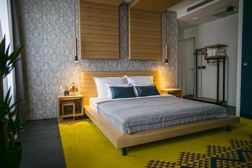 a bedroom with a large bed with blue pillows at Rooms Lejletul in Split