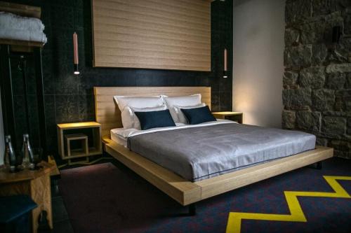 a bedroom with a large bed with two blue pillows at Rooms Lejletul in Split