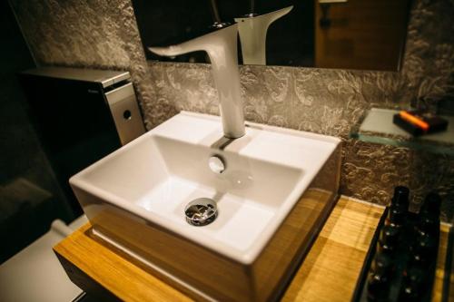a bathroom sink with a faucet on top of it at Rooms Lejletul in Split