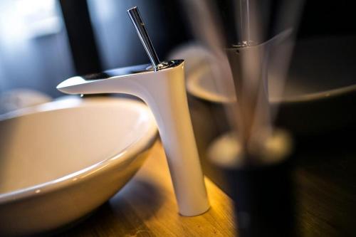 a white bowl with a toothbrush in it on a table at Rooms Lejletul in Split