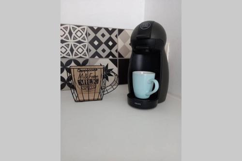 a coffee maker and a cup on a counter at La Trog'Laudy gîte 4 étoiles au coeur des vignes in Vouvray