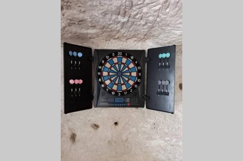 a dart board and two controllers on a wall at La Trog'Laudy gîte 4 étoiles au coeur des vignes in Vouvray