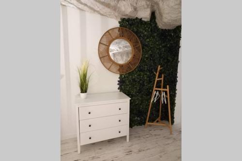 a room with a white dresser and a mirror at La Trog'Laudy gîte 4 étoiles au coeur des vignes in Vouvray