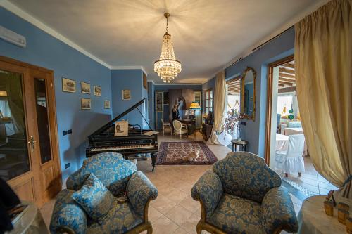 a living room with a piano and two chairs at Sotto il cielo di Toscana appartamenti in tenuta only adults no pet in Camaiore
