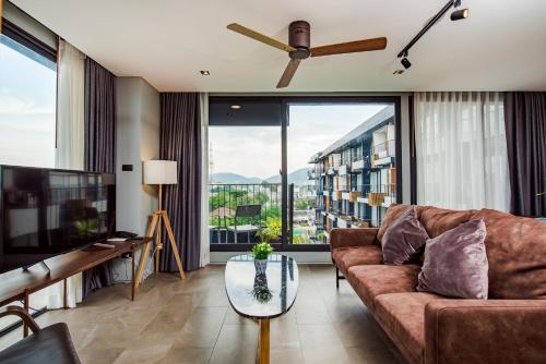 a living room with a couch and a glass table at Seamira House Huahin in Hua Hin