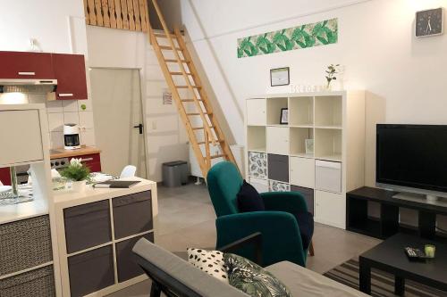 a living room with a kitchen and a living room with a tv at Work & Stay Apartments in Euskirchen in Euskirchen