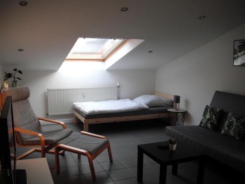 a room with a bed and a couch and a window at Work & Stay Apartments in Euskirchen in Euskirchen