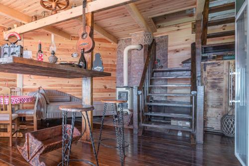 a log cabin with a bar and a stove at Holiday Village Ostrog in Nikšić