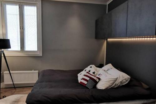 a bedroom with a bed with two pillows on it at Luxury apartment In the middle Of old Rauma in Rauma