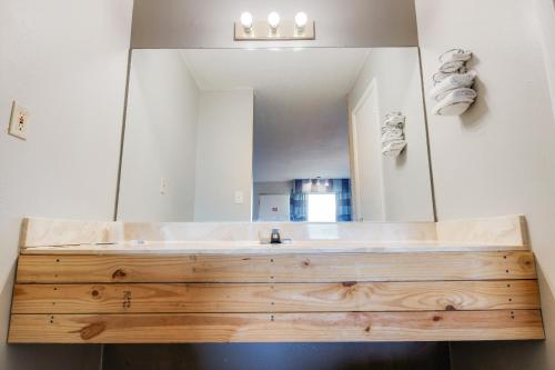 a bathroom with a large mirror and a wooden sink at Capital O 3Y Motel Mount Vernon Renfro Valley in Mount Vernon