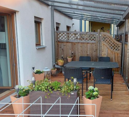 
a patio area with a patio table and chairs at Anitas Altstadtpension in Kelheim
