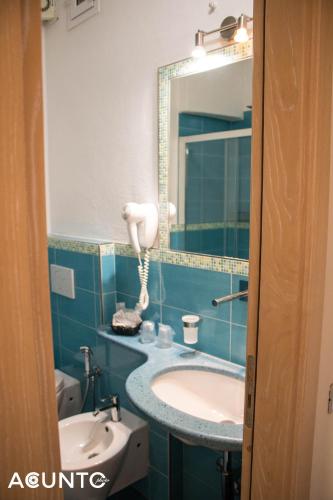 a bathroom with a sink and a mirror at Hotel Villa Cimmentorosso in Ischia