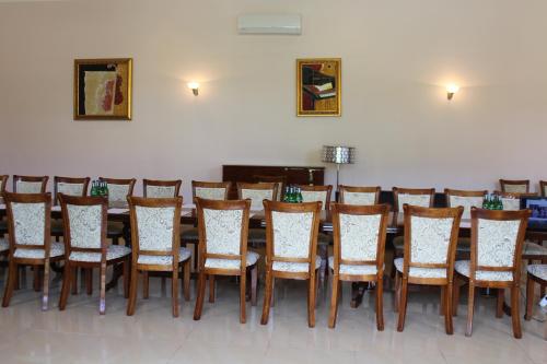 a row of tables and chairs in a room at Diligence Hotel & restaurant in Dilijan