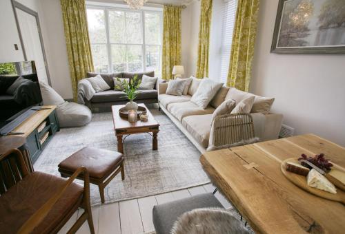a living room with a couch and a table at Bryn Afon in Betws-y-coed