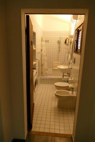 a bathroom with two toilets and a sink and a shower at PODERE 31 in Santa Margherita di Pula