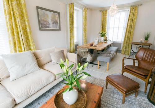 a living room with a couch and a table at Bryn Afon in Betws-y-coed