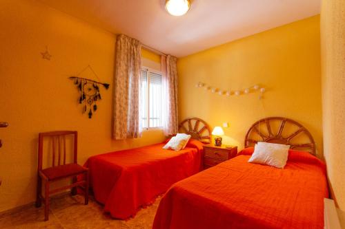 a bedroom with two beds and a window at INNOUTHOME Casa familiar, piscina a 200m de la playa Ham II in L'Ametlla de Mar