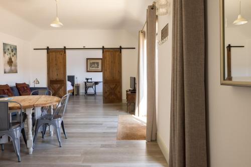 a dining room and living room with a table and chairs at Clopton Courtyard Cambridge in Cambridge