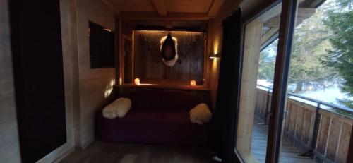 a small porch with a couch and candles on a balcony at Albergo Chalet Lago Antorno in Misurina