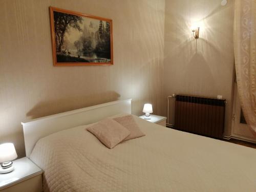 a bedroom with a white bed with two night stands at Lovely apartment in Pomer in Pomer