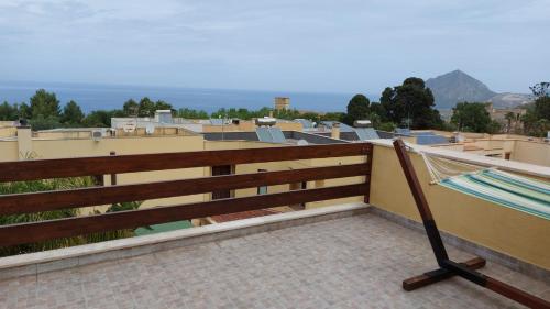a balcony with a hammock on the roof at B&B Verdeblu in Valderice