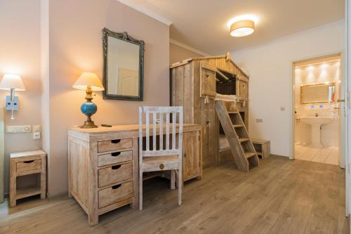 a bedroom with a bunk bed and a desk and a ladder at Hotel Koch Schilt in Irrel