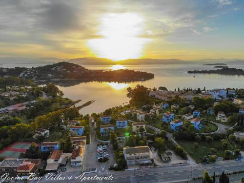 an aerial view of a town on the water with the sunset at Govino Bay in Gouvia