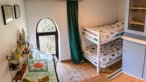 a bedroom with two bunk beds and a mirror at La Chapelle de verre, un lieu unique au monde in Ronquières