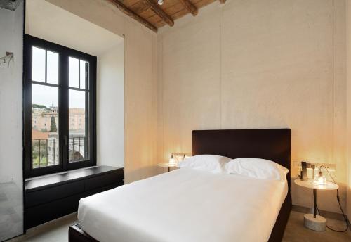 a bedroom with a white bed and a window at Rhinoceros in Rome