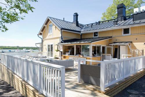 a house with a white picket fence at Hotel Amandis in Naantali