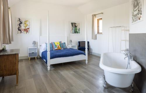 a bedroom with a bed and a tub and a sink at Clopton Courtyard Cambridge in Cambridge