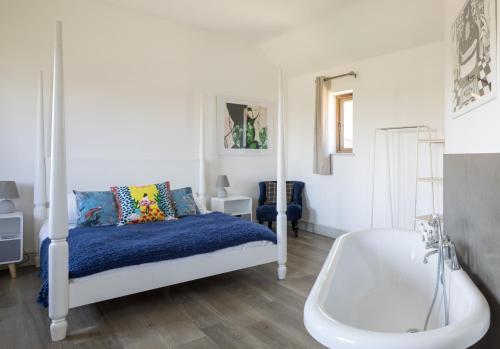 a bedroom with a bed and a bath tub at Clopton Courtyard Cambridge in Cambridge