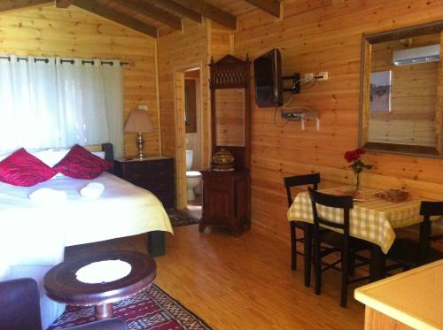 a bedroom with a bed and a table in a room at Villa Billy in Gan Ner