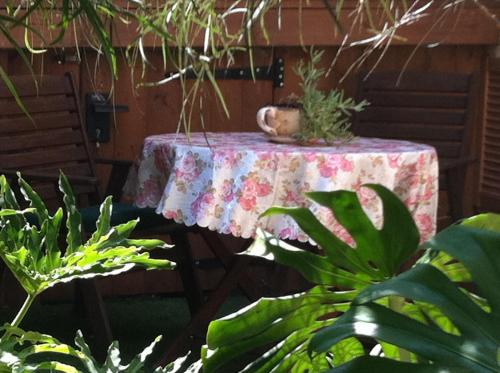 a table with a table cloth with a plant on it at Villa Billy in Gan Ner