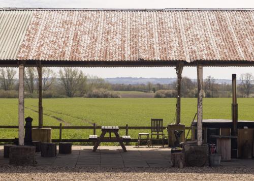a pavilion with a picnic table and a field at Clopton Courtyard Cambridge in Cambridge
