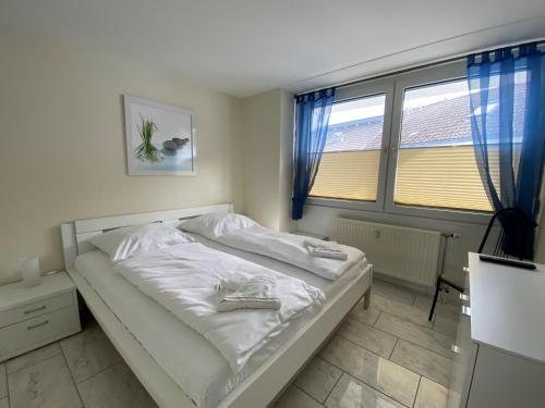 クックスハーフェンにあるSeemöwe Whg. 8のベッドルーム(白いベッド1台、窓付)