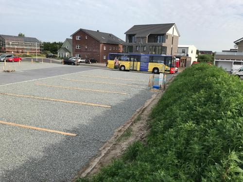a parking lot with a bus parked in it at WoMo-Stellplatz Schäfer in Sankt Peter-Ording