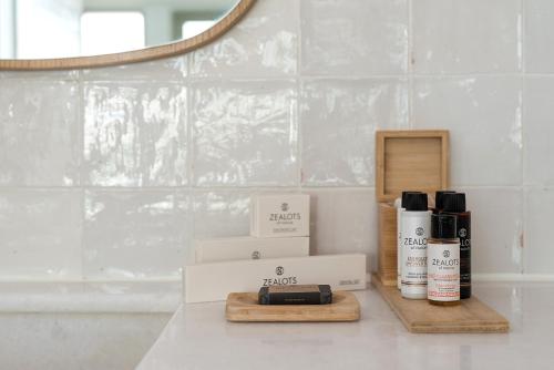 a bathroom counter with two boxes of products and a mirror at Coco-mat Athens BC in Athens