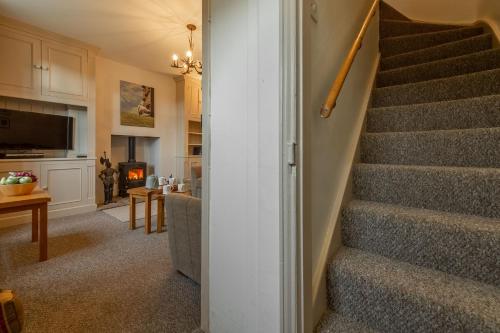 a stairway leading to a living room and a kitchen at Knights Rest in Redmire