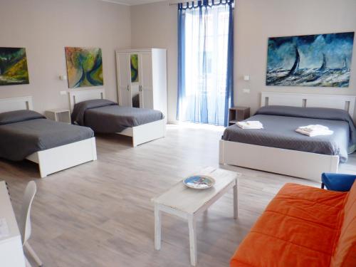 a living room with three beds and a couch at Sicania in Patti