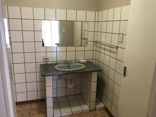 a bathroom with a sink and a mirror at UrbanLife Keetmanshoop Accommodation in Keetmanshoop
